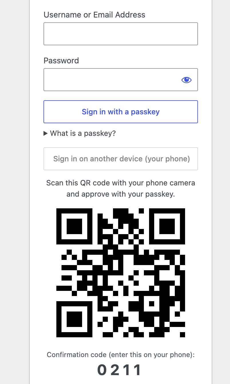 A QR code and confirmation code on the login screen, scanned with a phone and approved with a passkey.